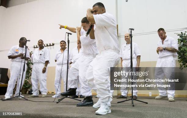 Maurice Castillo, right, and Preston Caroselli rap with a combined choir of inmates from the Jester 3 and Vance Units peform at St. Paul Baptist...