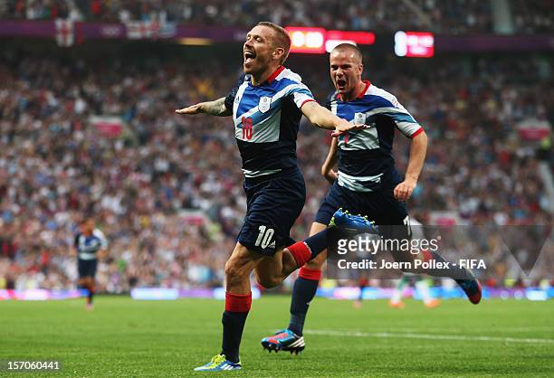 Craig Bellamy of Great Britain celebrates with his team mate Tom Cleverley after scoring his team's first goal during the Men's Football first round...