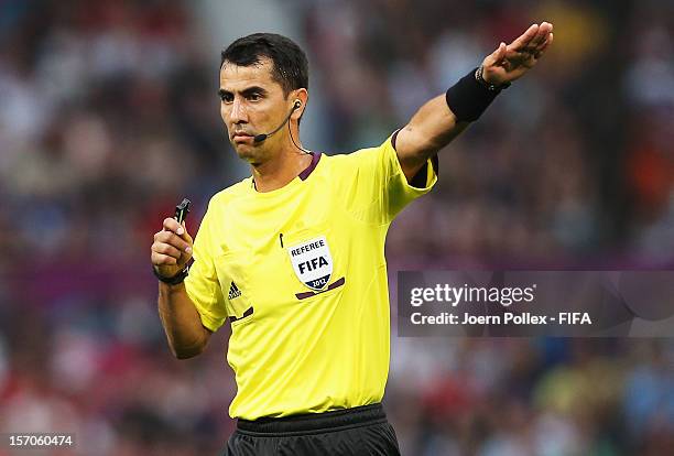 Referee Ravshan Irmatov gestures during the Men's Football first round Group A Match of the London 2012 Olympic Games between Great Britain and...