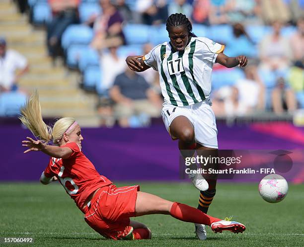 Andisiwe Mgcoy of South Africa challenges for the ball with Kaylyn Kyle of Canada during the Women's Football first round Group F Match of the London...