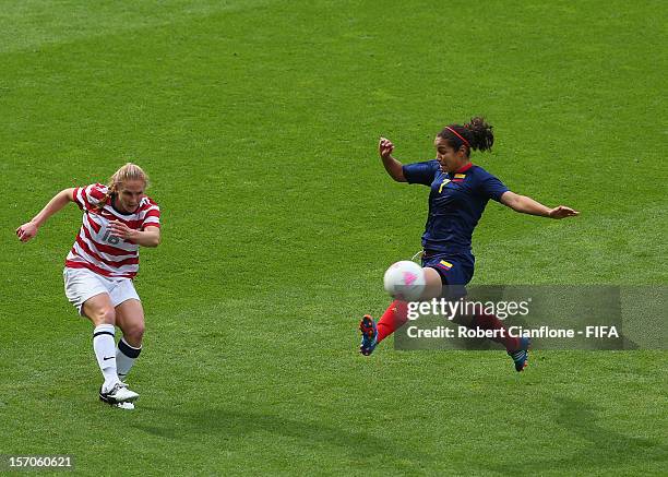 Rachel Buehler of the USA kicks the ball past Orianica Velasquez of Colombia during the Women's Football first round Group G Match of the London 2012...