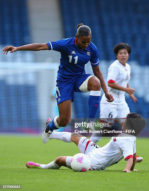 Marie-Laure Delie of France leaps over Nam Hui Kim of Korea DPR during the Women's Football first round Group G Match of the London 2012 Olympic...