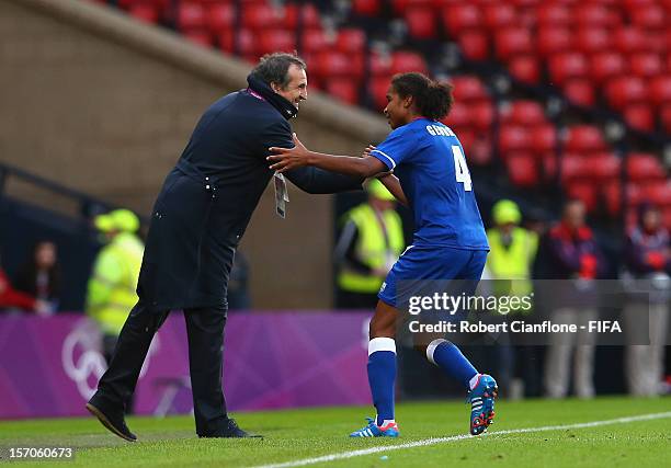 Laura Georges of France celebrates her goal with coach Bruno Bini during the Women's Football first round Group G Match of the London 2012 Olympic...