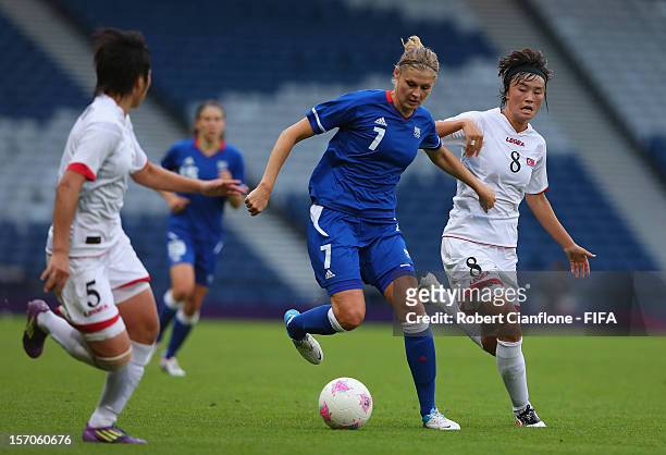 Corine Franco of France runs with the ball during the Women's Football first round Group G Match of the London 2012 Olympic Games between France and...