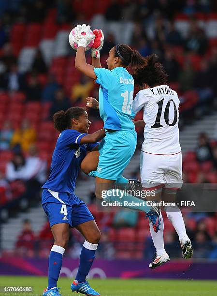 French goalkeeper Sarah Bouhaddi takes the ball during the Women's Football first round Group G Match of the London 2012 Olympic Games between France...