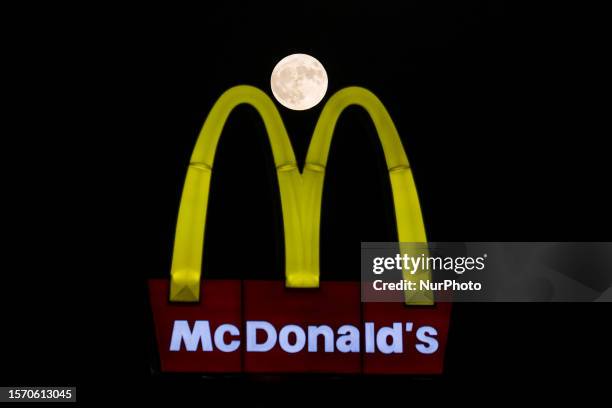 The Sturgeon Moon is seen behind a McDonald's sign, Nicosia, Cyprus, on Aug. 1, 2023. Since this full Moon is less than 12 hours before perigee ,...