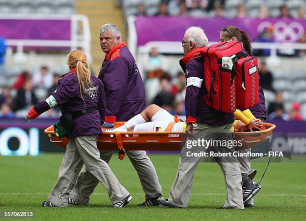 Catalina Usme of Colombia is taken from the ground with an injury during the Women's Football first round Group G match between France and Colombia...