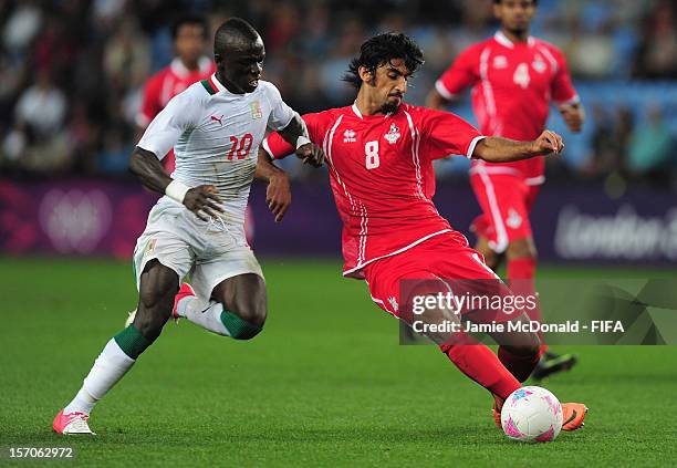 Sadio Mane of Senegal battles with Hamdan Al Kamali of United Arab Emirates during the Men's Football first round Group A Match between Senegal and...