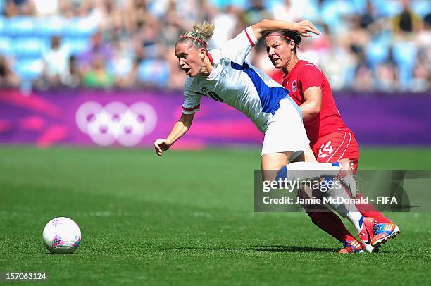 Melissa Tancredi of Canada battles with Camile Abily of France during the Women's Football Bronze Medal match between Canada and France, on Day 13 of...