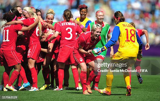 Sophie Schmidt and Erin McLeod of Canada celebrate Bronze during the Women's Football Bronze Medal match between Canada and France, on Day 13 of the...