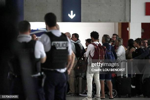 People arrive at Paris Roissy Charles de Gaulle airport in Roissy-en-France, near Paris on August 2 after being evacuated from Niger. The first of...