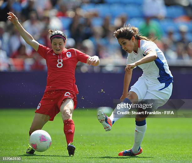 Diana Matheson of Canada challenges for the ball with Louisa Necib of France between the Olympic womens bronze medal match between Canada and France...