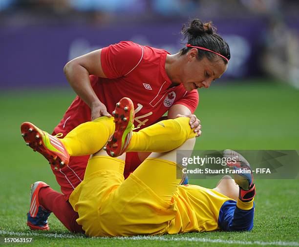 Melissa Tancredi of Canada tends to Erin McLeod of Canada between the Olympic womens bronze medal match between Canada and France on day 13 of the...