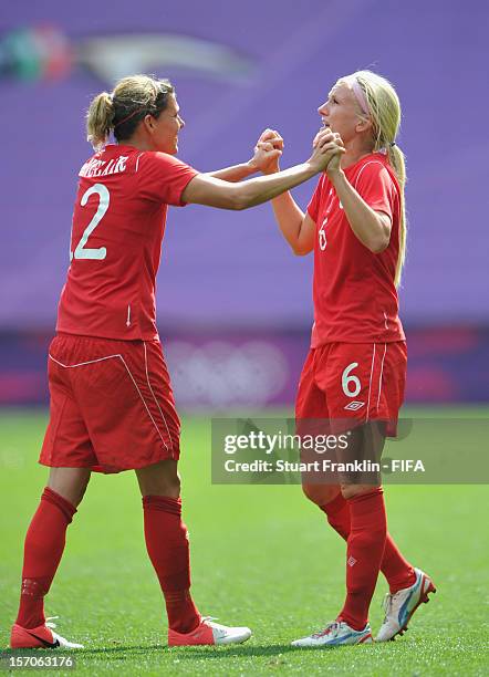 Christine Sinclair and Kaylyn Kyle of Canada celebrate at the end of the Olympic womens bronze medal match between Canada and France on day 13 of the...