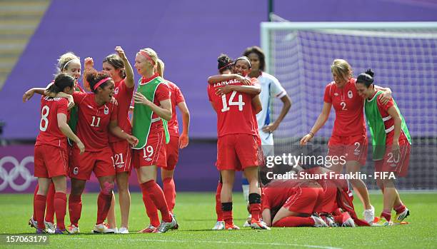 The players of Canada celebrate at the end of the Olympic womens bronze medal match between Canada and France on day 13 of the London 2012 Olympic...