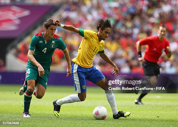 Neymar of Brazil is chased by Hiram Mier of Mexico during the Men's Football Gold Medal match between Brazil and Mexico on Day 15 of the London 2012...