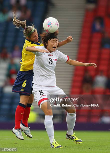 Myong Hwa Jon of Korea DPR is challenged by Daniela Montoya of Colombia during the Women's Football first round Group G Match of the London 2012...