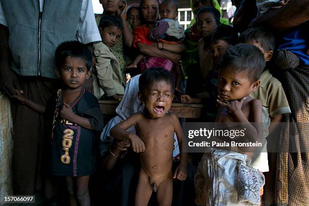 Rohingya children waits for medical care at a school that is now a makeshift IDP camp November 24, 2012 on the outskirts of Sittwe, Myanmar. An...