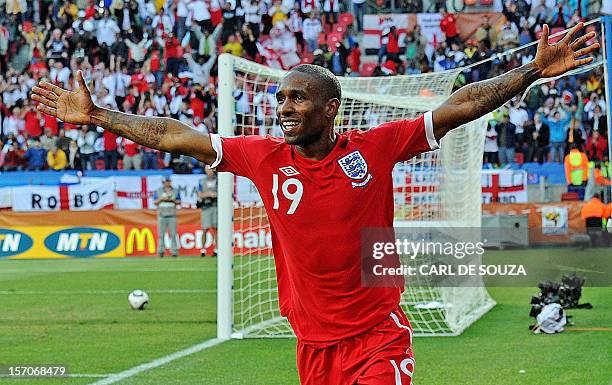 England's striker Jermain Defoe celebrates after scoring the opening goal during the Group C first round 2010 World Cup football match Slovenia vs....