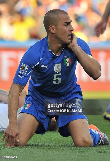 Italy's defender Fabio Cannavaro reacts while on his knees after a challenge during the Group F first round 2010 World Cup football match between...