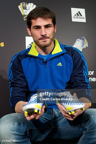 Real Madrid's goalkeeper Iker Casillas presents the new adidas Predator Boots and Soccer Gloves at the Soloporteros store on November 28, 2012 in...