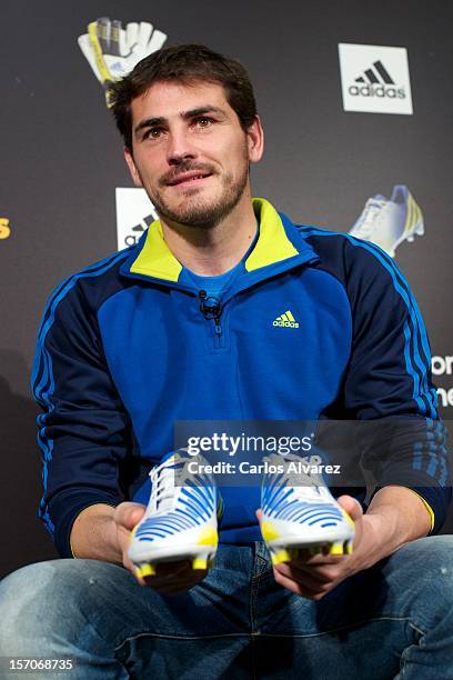 Real Madrid's goalkeeper Iker Casillas presents the new adidas Predator Boots and Soccer Gloves at the Soloporteros store on November 28, 2012 in...