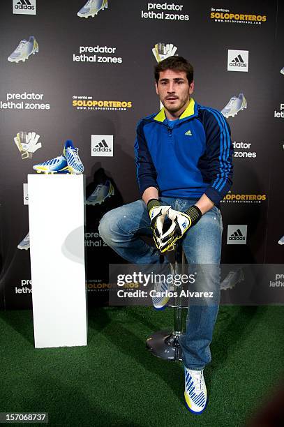 Real Madrid's goalkeeper Iker Casillas presents the new adidas Predator Boots and Soccer Gloves at the Soloporteros store on November 28, 2012 in...