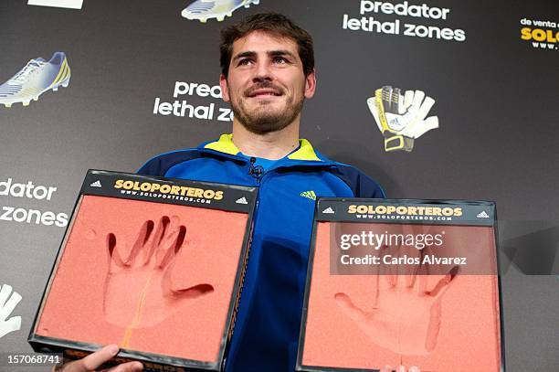 Real Madrid's goalkeeper Iker Casillas presents the new adidas Predator Boots and Soccer Gloves at the Soloporteros store on November 28, 2012 in...