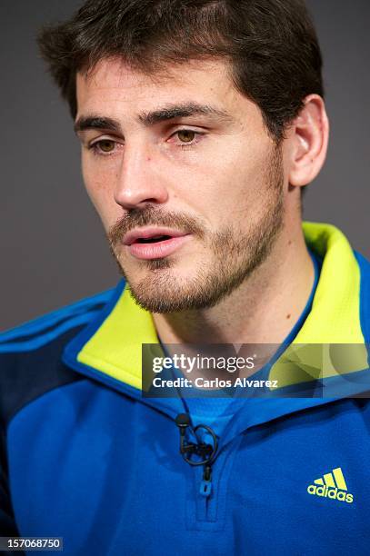 Real Madrid's goalkeeper Iker Casillas presents the new adidas Predator Boots and Soccer Gloves at the Soloporteros store on November 28, 2012 in...