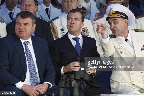 Russian President Dmitry Medvedev , Defence Minister Anatoly Serdyukov and the Commander-in-chief of the Navy Vladimir Vysotsky watch a parade at...