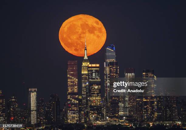 Super Moon rises over the Empire State Building in New York City, US on AUGUST 1, 2023.