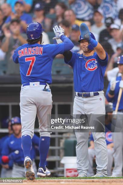 Dansby Swanson of the Chicago Cubs celebrates with Seiya Suzuki after hitting a two-run home run off Michael Kopech of the Chicago White Sox during...