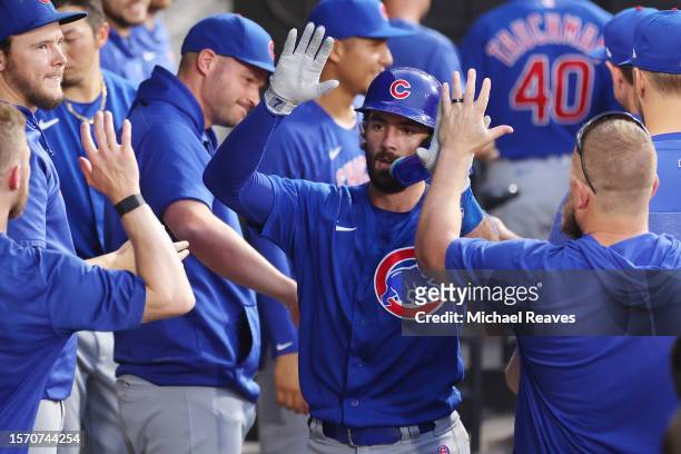 Dansby Swanson of the Chicago Cubs high fives teammates after hitting a solo home run off Michael Kopech of the Chicago White Sox during the fourth...