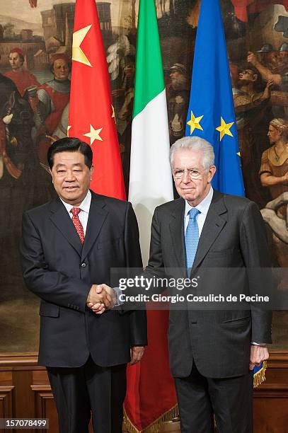Jia Qinglin , Chairman of the National Committee of the Chinese People's Political Consultative Conference, shakes hand with Italian Prime Minister...