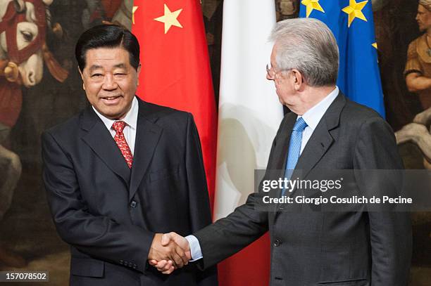 Jia Qinglin , Chairman of the National Committee of the Chinese People's Political Consultative Conference, shakes hand with Italian Prime Minister...