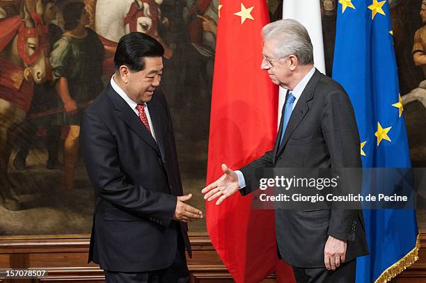 Jia Qinglin , Chairman of the National Committee of the Chinese People's Political Consultative Conference, shakes hand with Italian Prime Minister...