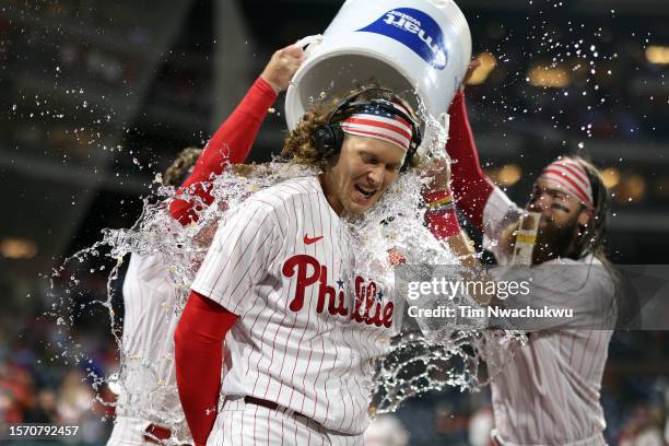 Alec Bohm of the Philadelphia Phillies receives a water shower after hitting a walk-off RBI single against the Baltimore Orioles at Citizens Bank...