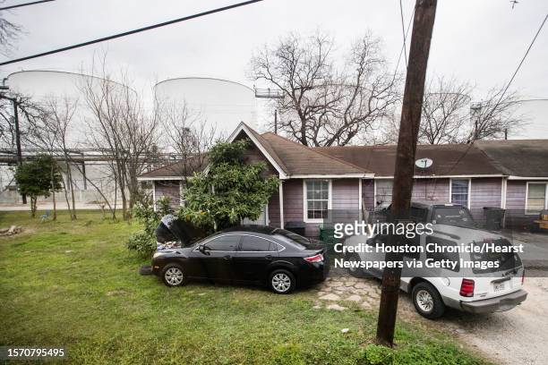 Petrochemical storage tanks rise above a house shown through the window of a bush during a tour dubbed a Toxic Tour on Saturday, Feb. 9 in Houston....
