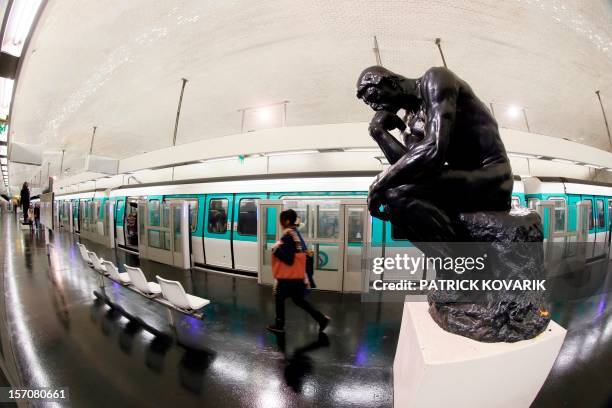 Picture shows a copy of the statue "The Thinker" by French sculptor Auguste Rodin in the Varenne metro station in Paris on November 27, 2012. AFP...
