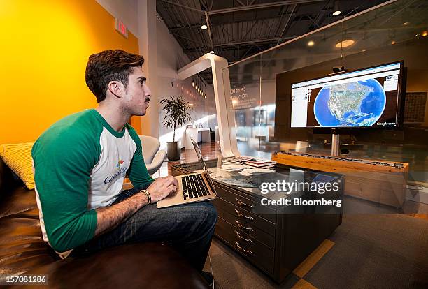 Tom Fitzgerald, a Google Inc. Fiber Space team member, demonstrates upload speeds while using Google Earth in the showroom of the Fiber Space office...