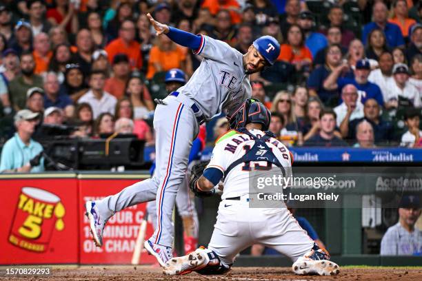 Martin Maldonado of the Houston Astros tags out Marcus Semien of the Texas Rangers at Minute Maid Park on July 25, 2023 in Houston, Texas.