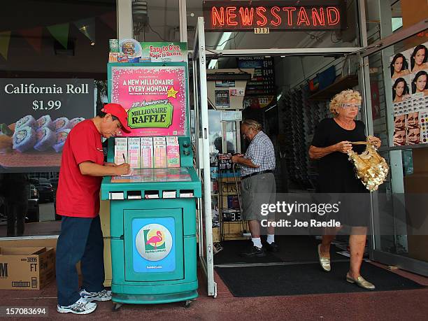 Julio Caso fills out his Powerball numbers as he buys a ticket at Circle News Stand on November 28, 2012 in Hollywood, Florida. The jackpot for...