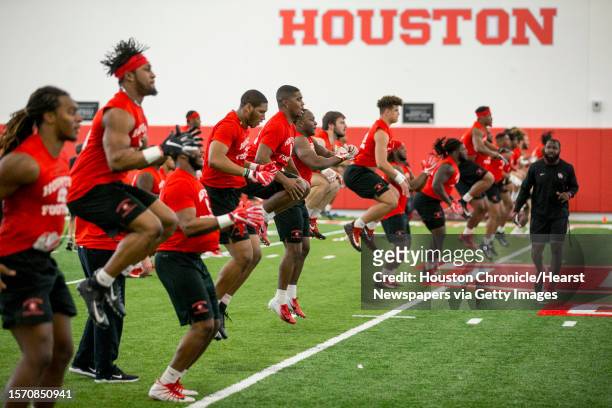 University of Houston defensive players warm up during the first day of spring practice on Tuesday, March 19 in Houston.