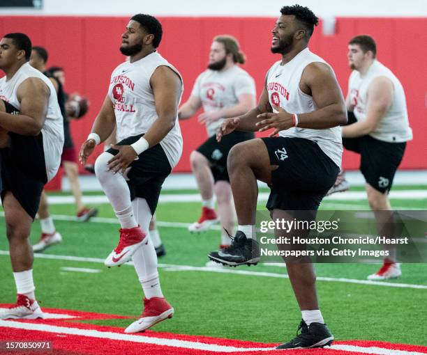 Houston offensive linemen Keenan Murphy, left, and Josh Jones warm up during the first day of spring practice on Tuesday, March 19 in Houston.