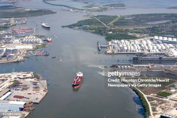 Maritime traffic moves through the Houston Ship Chanel past the site of now-extinguished petrochemical tank fire at Intercontinental Terminals...