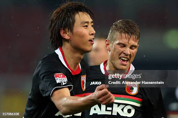 Ja-Cheol Koo of Augsburg celebrates scoring his first team goal with his team mate Matthias Ostrzolek during the Bundesliga match between VfB...