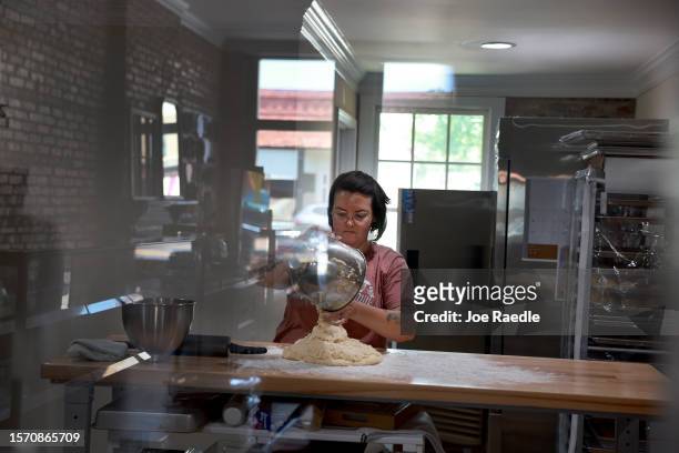 Christina Capelle works on creating cinnamon rolls at her Hampton House Bakery on July 25, 2023 in Hawkinsville, Georgia. Capelle said she would...