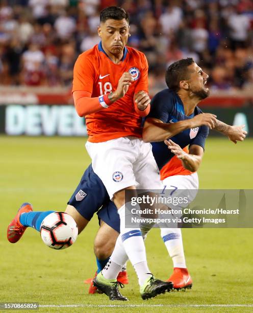 Chile defender Gonzalo Jara and United States midfielder Sebastian Lletget collide during the second half of an international friendly soccer match...
