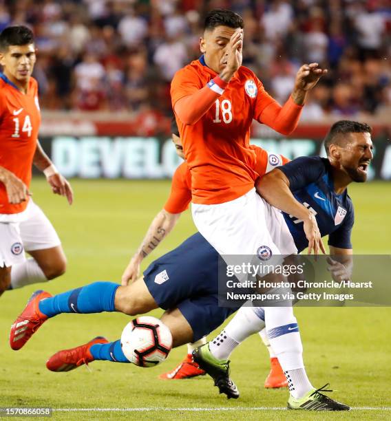 Chile defender Gonzalo Jara and United States midfielder Sebastian Lletget collide during the second half of an international friendly soccer match...