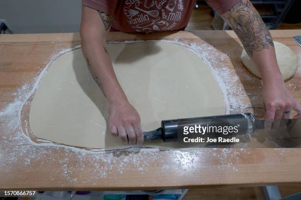 Christina Capelle rolls out the dough as she creates cinnamon rolls at her Hampton House Bakery on July 25, 2023 in Hawkinsville, Georgia. Capelle...